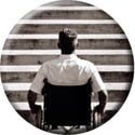 Image of man in wheelchair facing stairs